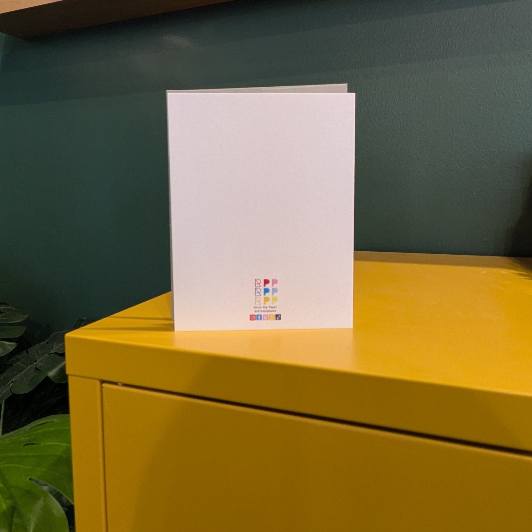 Back a card with RPP logo on yellow surface