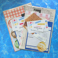 Collection of scrapbook materials on a blue cutting mat